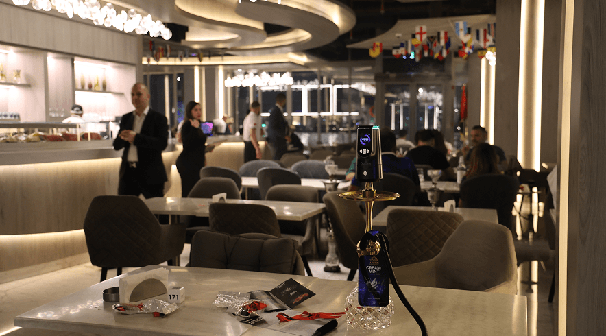 An XKAH heat manager set up on a table in a lit restaurant dining room