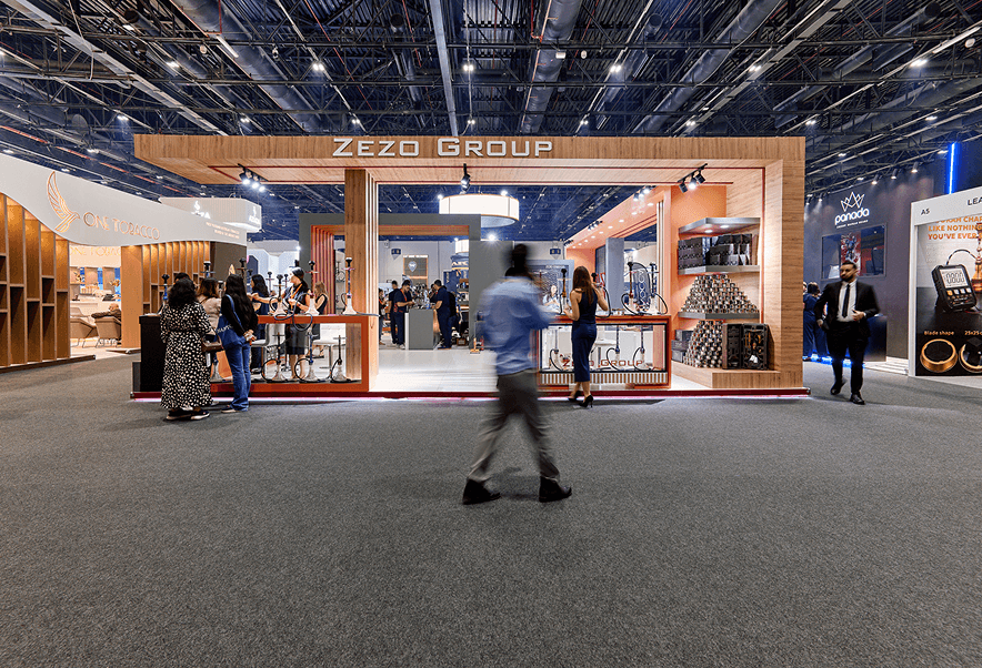 The ZEZO Group stand at a trade exhibition, with visitors browsing the displays